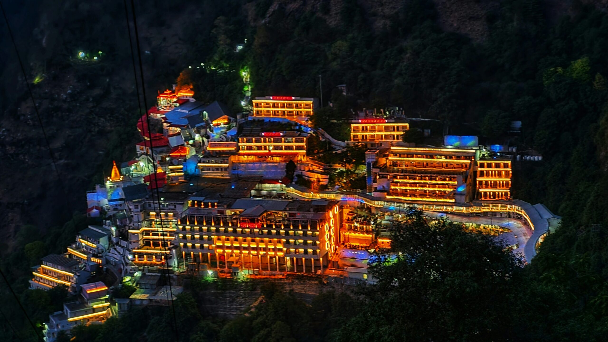 Aerial view of Vaishno Devi temple complex nestled in snow-capped Trikuta Mountains Jammu Kashmir